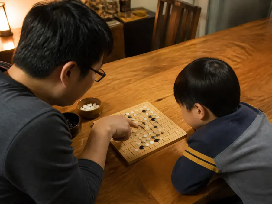 Two people discussing a Go position